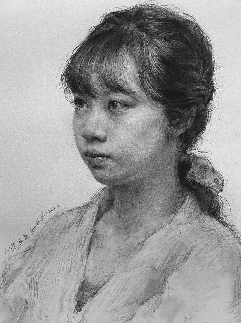 Graphite portrait of a young woman in three-quarter view